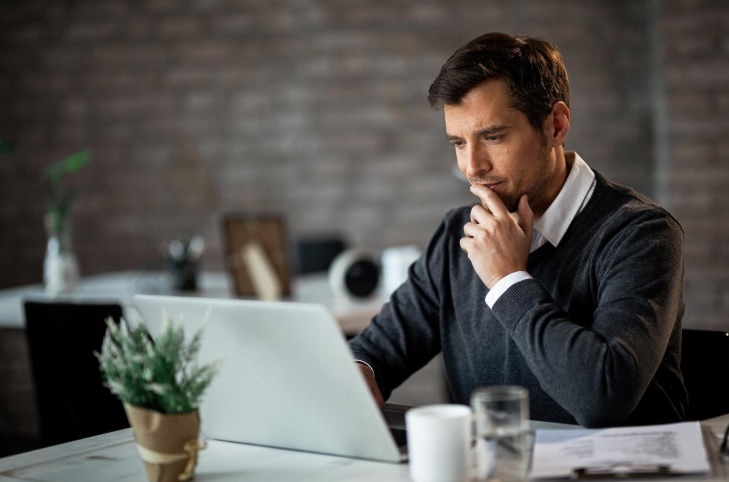 a man thinking while looking for msp for his business