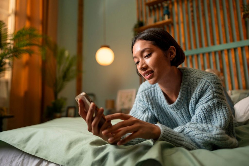 person using mobile phone in the morning