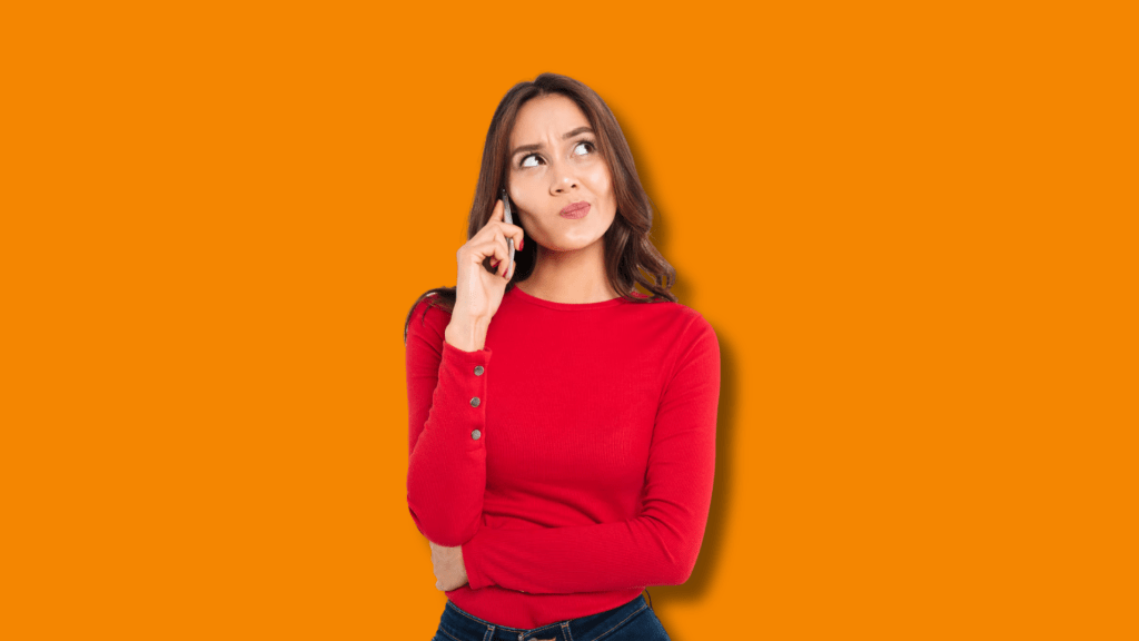 A woman thinking with orange background.