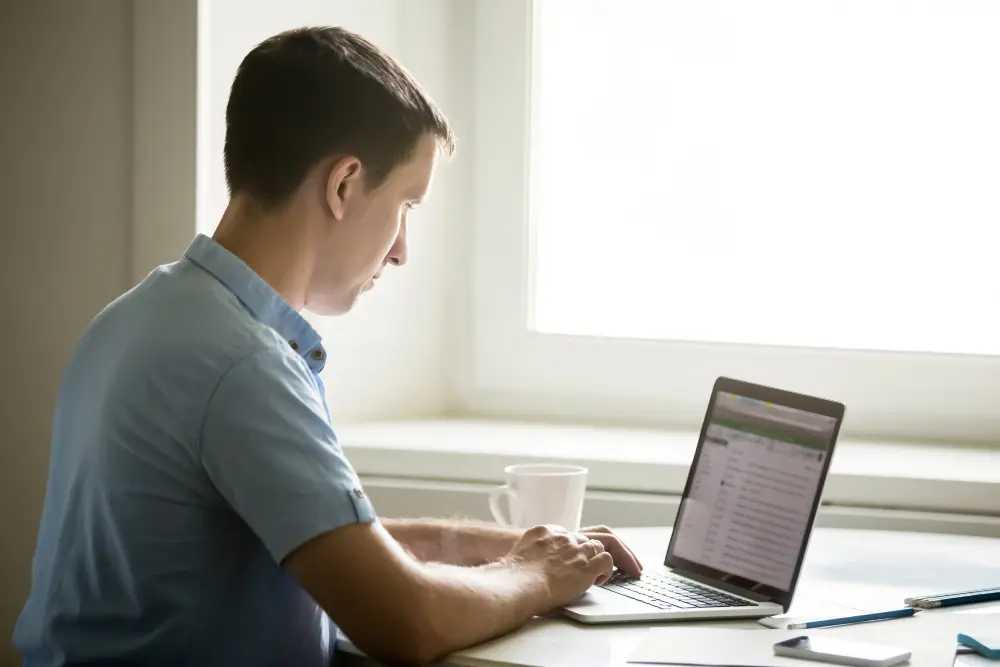 A man working on the company licenses and updating security.
